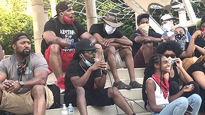 RJC Asheville members attend a Saturday Night Vigil for Black lives lost to police violence at the June 6th, 2020 protest for Black Liberation. Protestors sit in Pack Square Park in front of Asheville City Hall.