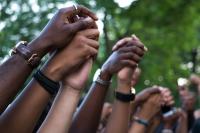 Image: holding hands. Topic: People of Color Are on the Front Lines of the Climate Crisis