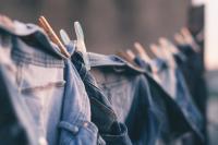 Image: Jeans hanging on a clothesline. Topic: sweatshop-free clothing.