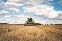 Image: wheat harvester in field. Topic: What is Carbon Farming?