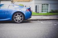 Image: blue car in parking spot. Topic: Reduce Your Carbon Footprint