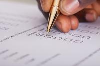 Image: pen in hand signing a ballot. Title Holding Companies Accountable through Shareholder Activism