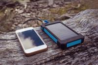 Image: phone being charged by small solar panel. Title: Find Renewable Energy Products for Less