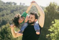 father lifting his daughter playfully