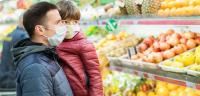 Image: masked parent holding child in supermarket. Title: "Don't Discount Our Future" Campaign Targets Trader Joe's Cocoa Sourcing and Climate-Damaging Refrigeration