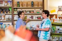 Shelley and Julie by the coffee and tea wall at The Green Corner Store. Organic tea.