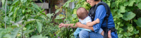 NIcky Schauder weeding with her child.