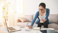 woman accounting and holding paper receipts