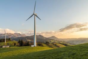 Image: wind turbines on green hills. Title: Green America Applauds T-Mobile, AT&T, and Sprint for Major New Advances on Renewable Energy