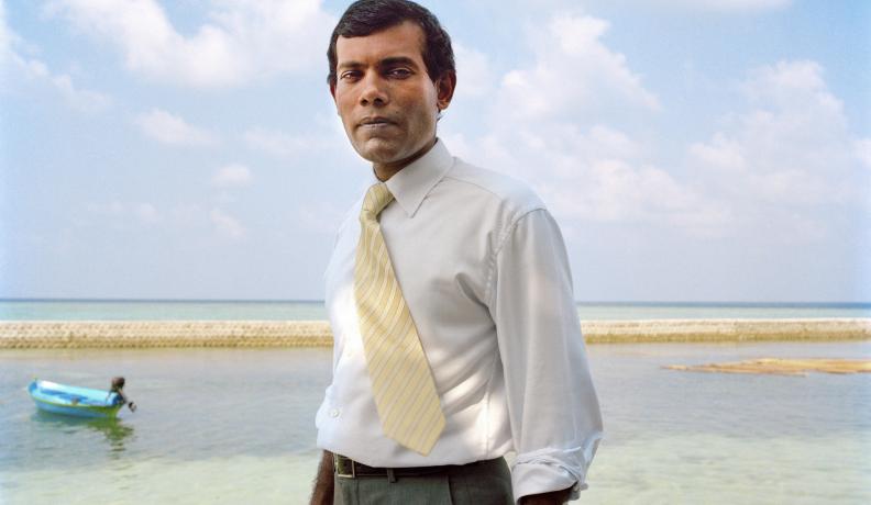 Image: Mohamed Nasheed standing on beach. Title: Mohamed Nasheed: Climate Champion for the World’s Most Vulnerable