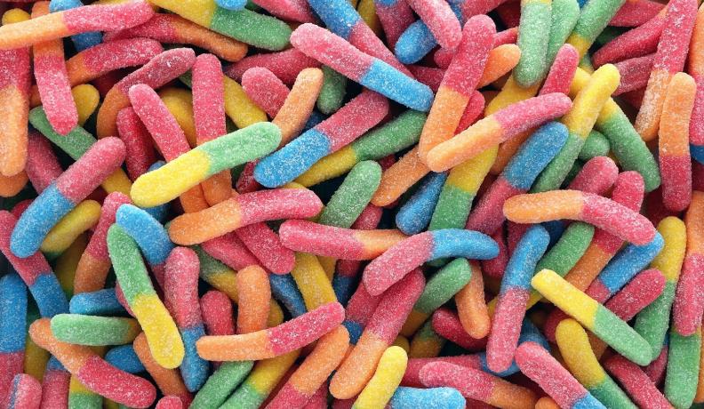 Image: colorful gummy worms. Title: The Sweet Side of Fair Trade 