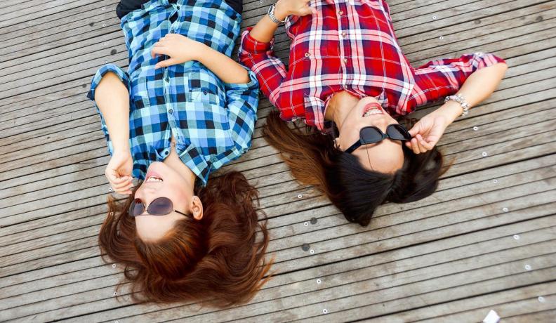 Two women with plaid shirts via Pexel