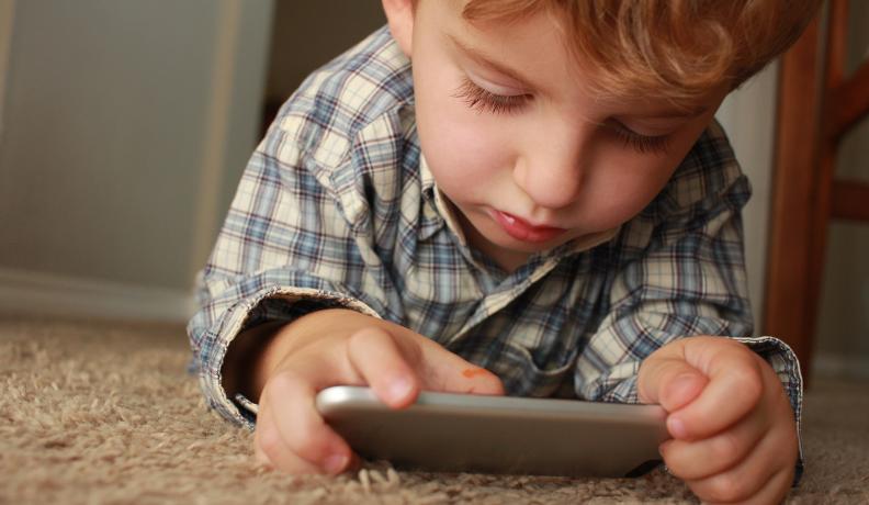 kid playing on a cell phone