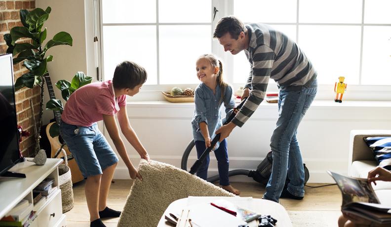 Image: dad and kids vacuuming, creating a germ-free home