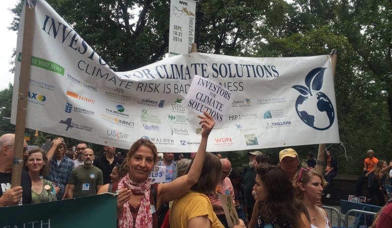 Shareholder activists from the Interfaith Center on Corporate Responsibility urge others to join them in addressing companies’ lack of action on global warming at the People’s Climate March in 2014. 