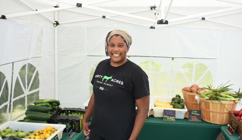 Liz Abunaw poses in her market in a tent