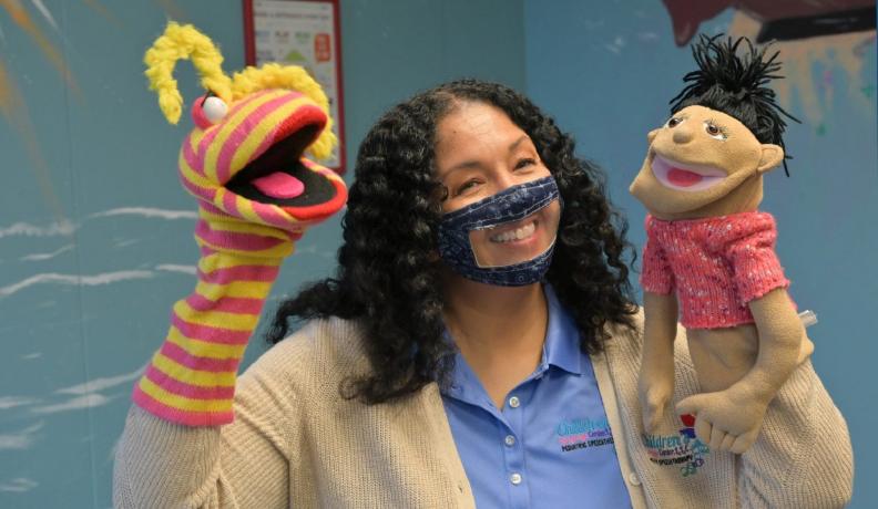 woman holding puppets