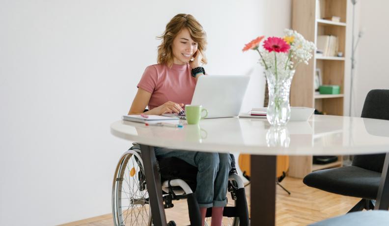 woman in wheelchair at table