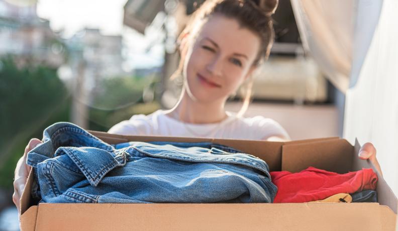 woman holding box of clothes