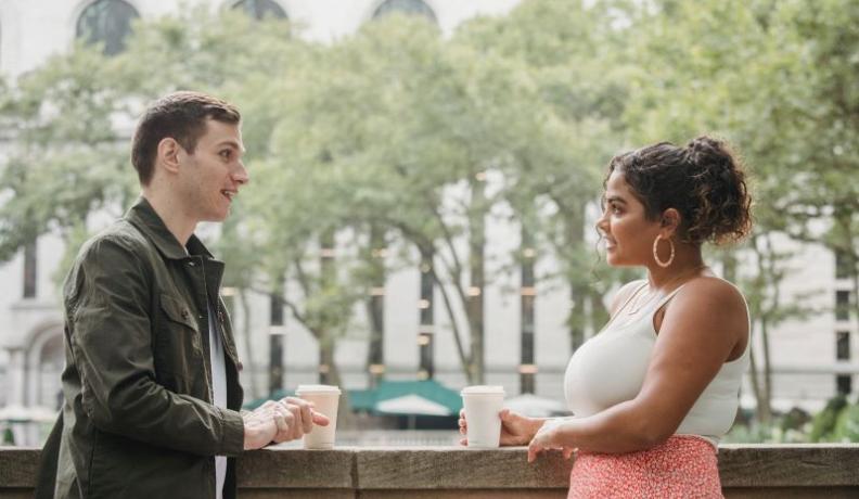 couple drinking coffee outdoors