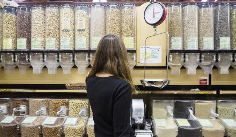 woman shopping in the bulk aisle