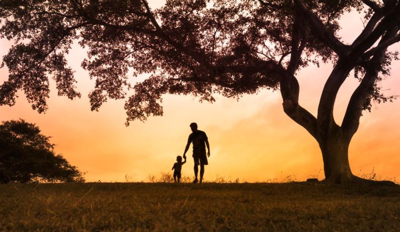 father and sun silhouette during sunset