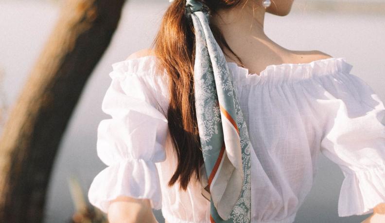 white woman wearing a head scarf in her hair