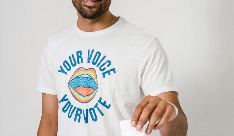 Man putting his vote into a ballot box