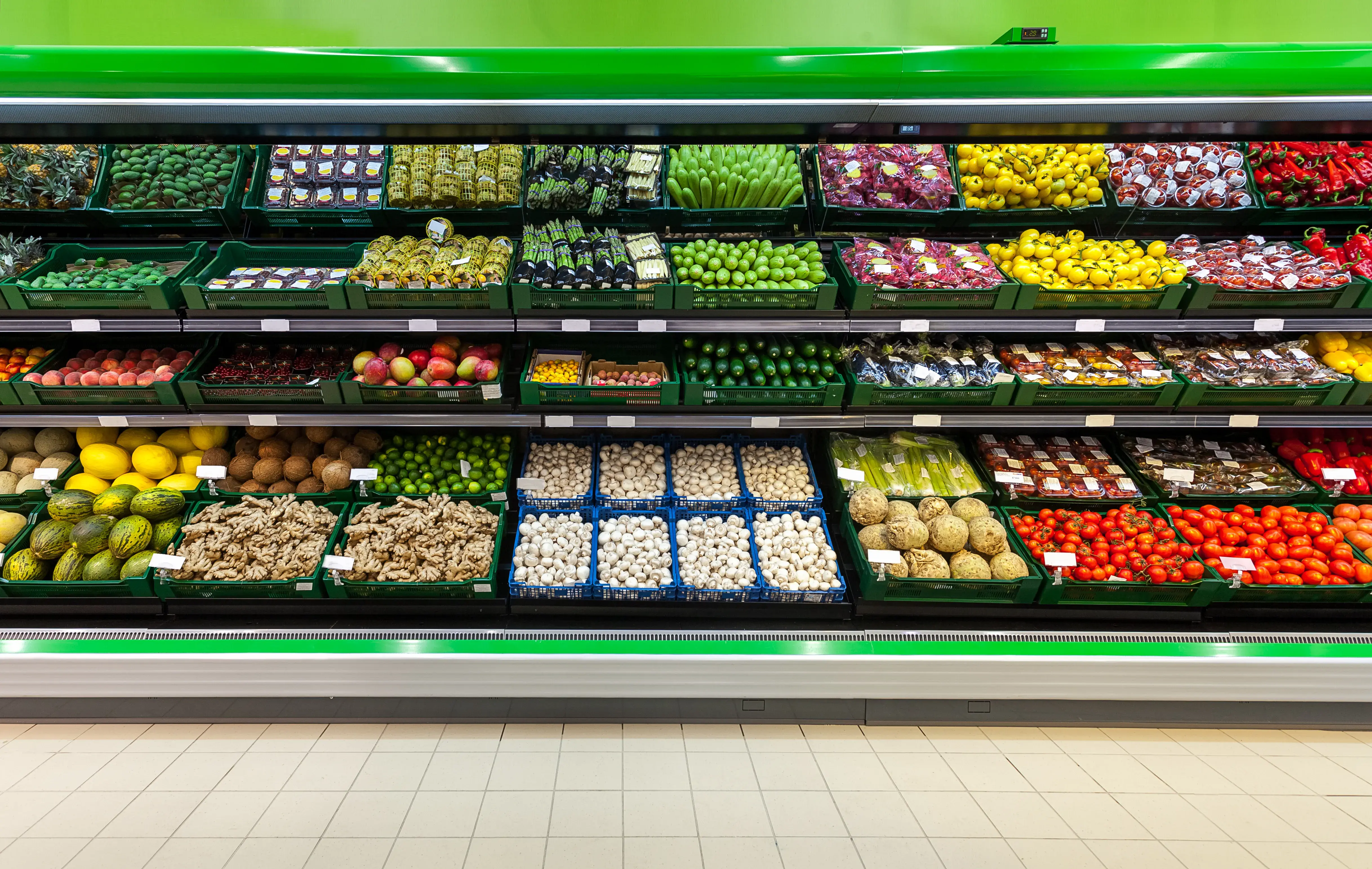 grocery store aisle of refrigerated vegetables and fruit