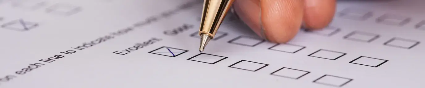 Image: pen in hand signing a ballot. Title Holding Companies Accountable through Shareholder Activism