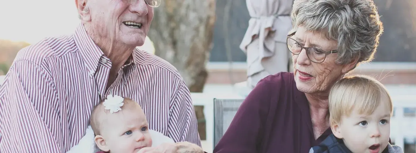 grandparents holding grandchildren