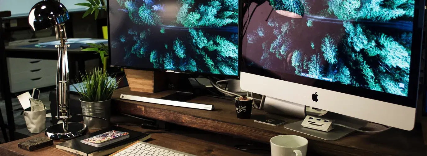 Image: two-screen computer desk set-up. Topic: Sustainable Computer Options