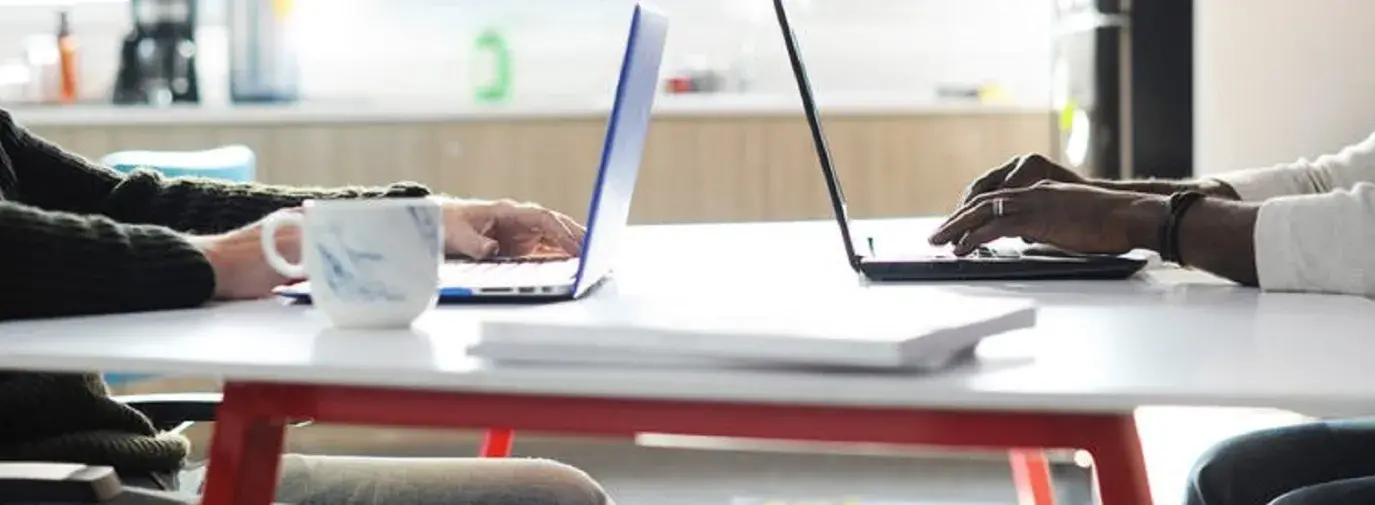 two men sitting at their desk