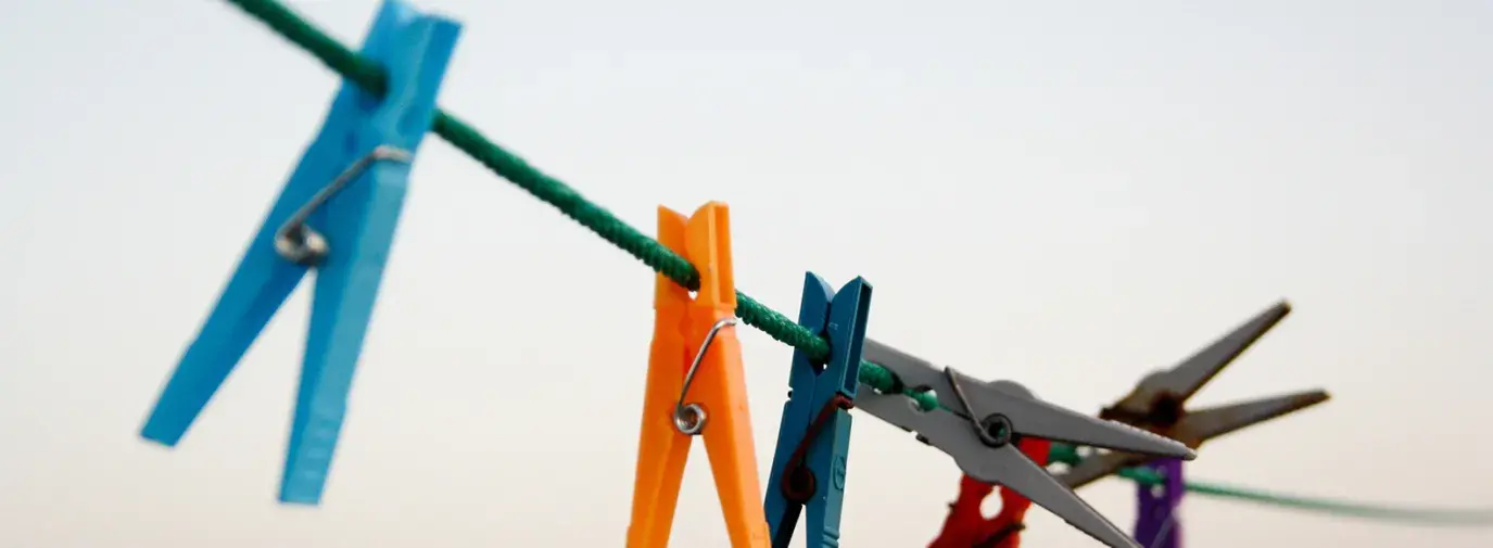 Image: clothespins on a line. Title: Going Green: Eco-Friendly Laundry Products