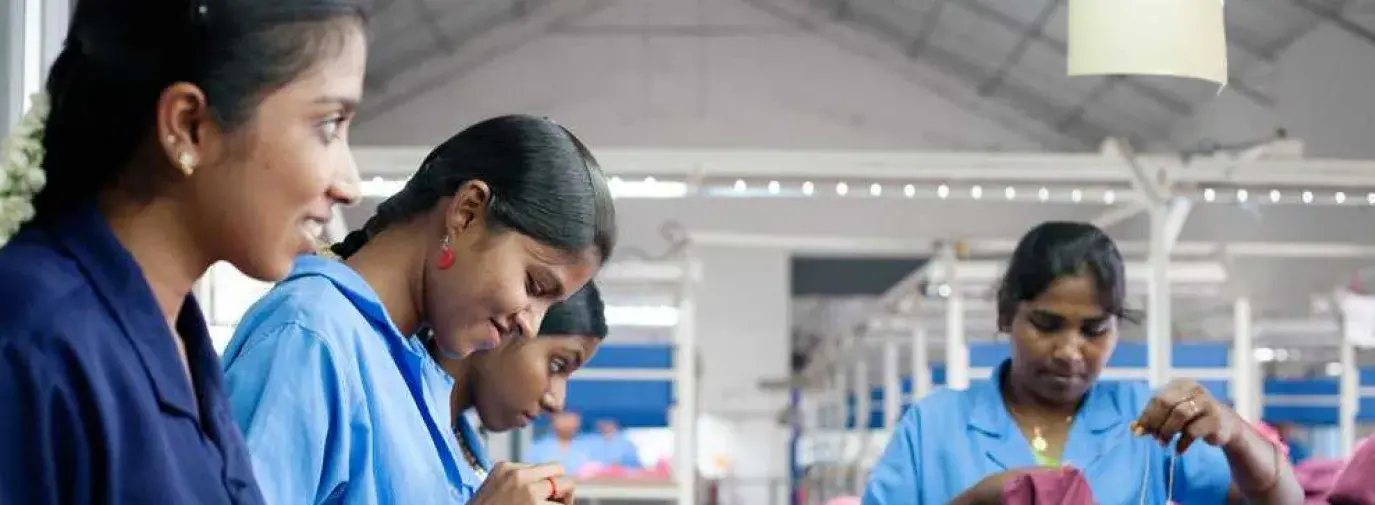 Image: women working with textiles. Title: In Search of Ethical Fashion