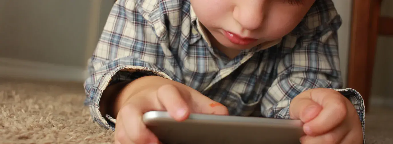 kid playing on a cell phone