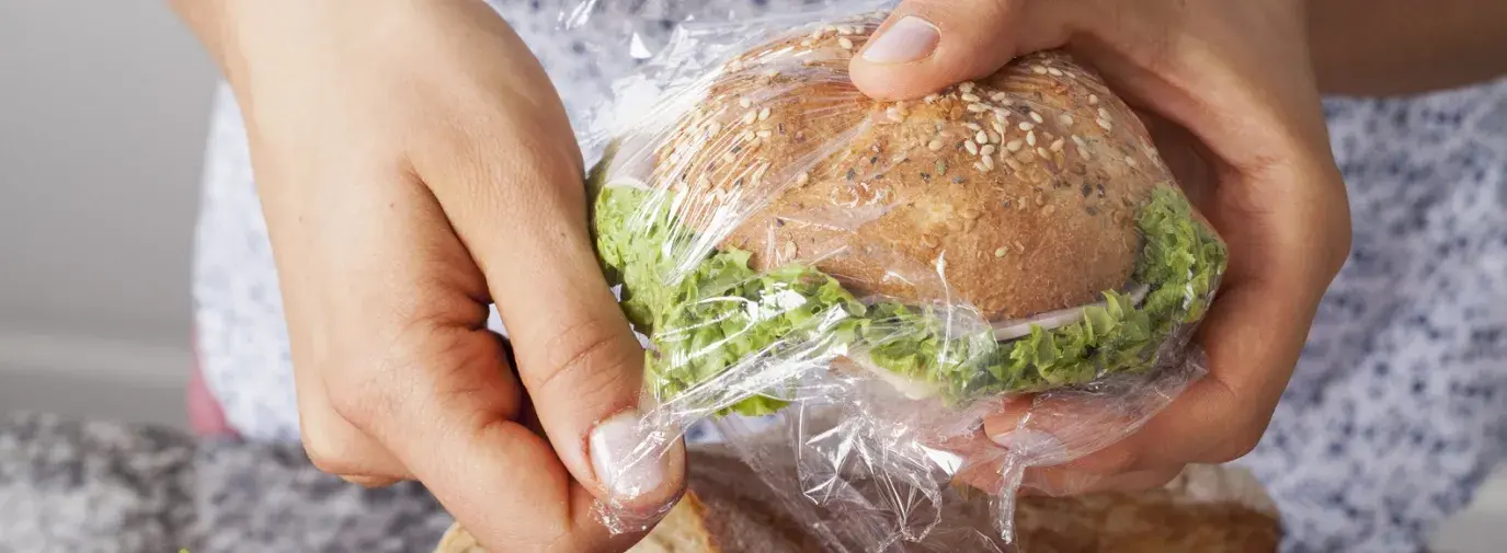 woman wraps sandwich in plastic