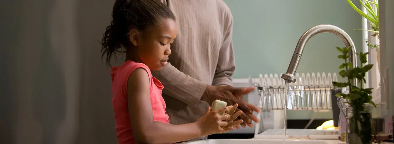 father and daughter handwashing 