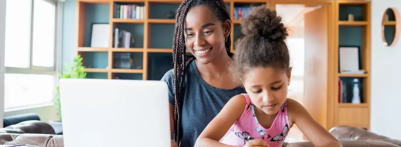 woman and daughter sitting at the computer