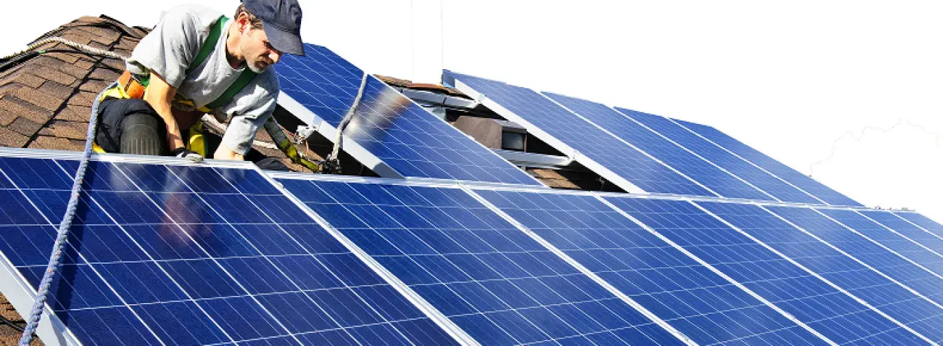 solar technician installing solar panels on a roof