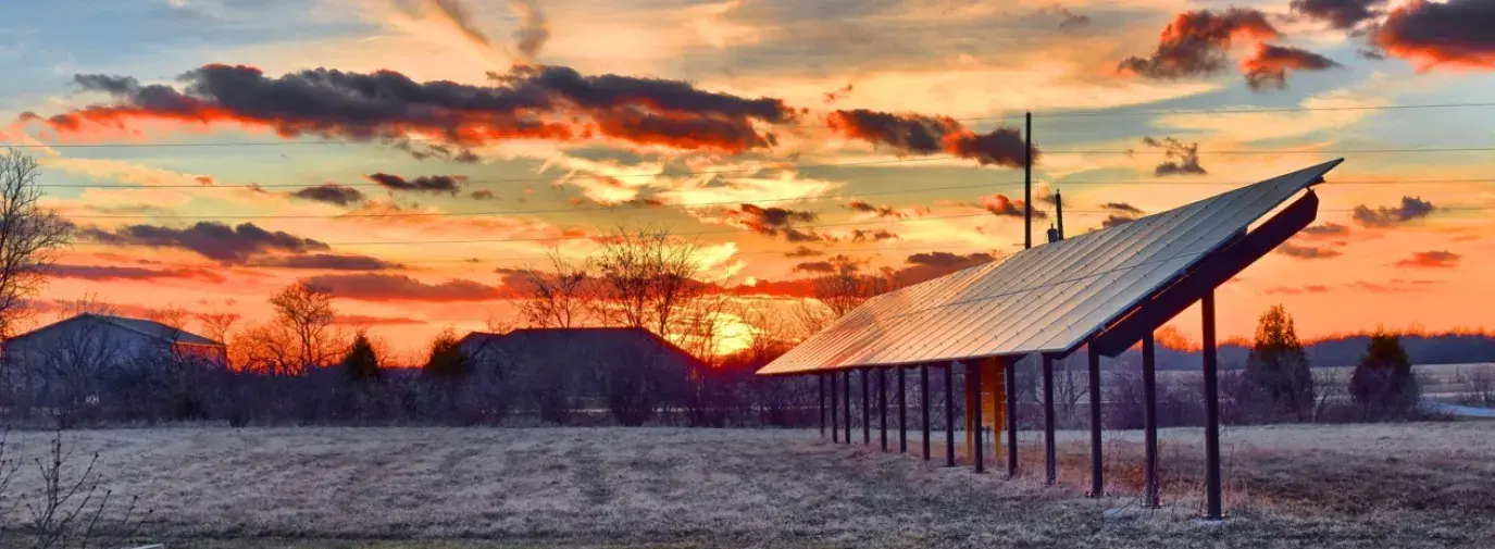 Image: sunset on solar panels. Title: Clean Energy Mutual Funds