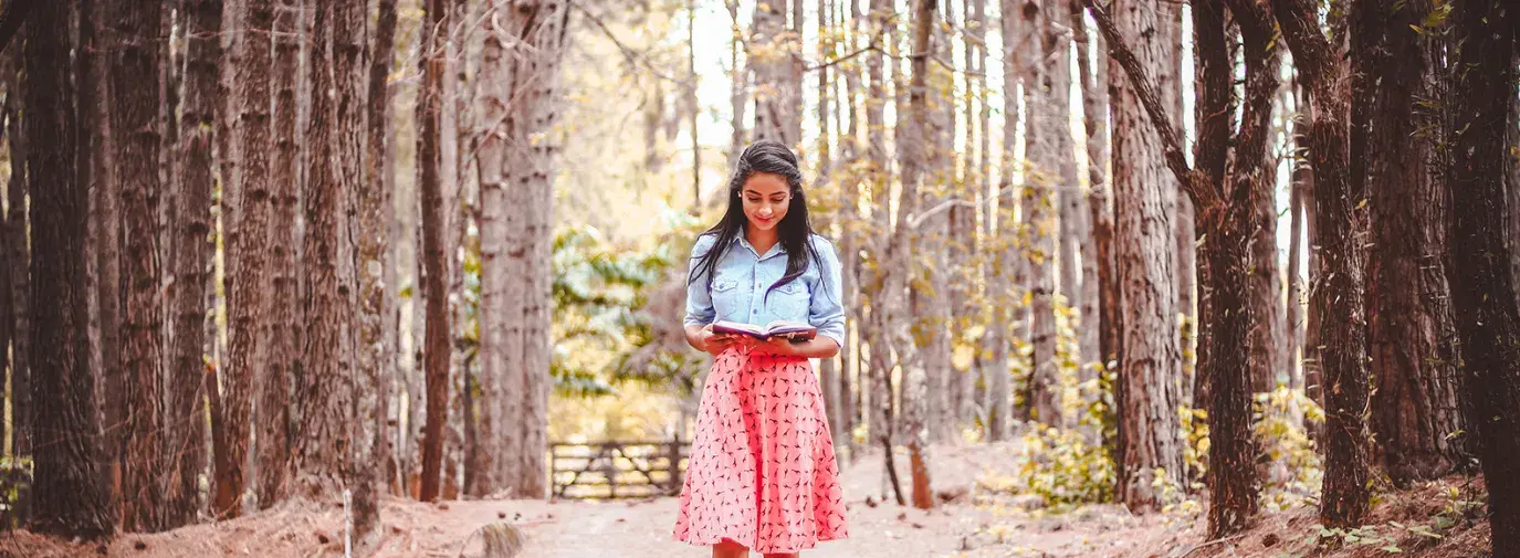 woman walking in trees