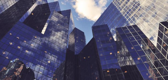 Image: upward view of skyscrapers. Topic: Break up with your mega-bank