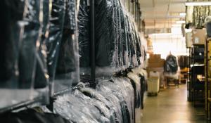 Image: suit rack at dry cleaners. Topic: Green Dry Cleaning