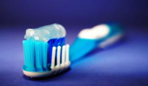 Image: toothbrush with toothpaste. Topic: Less-Toxic Dentistry: Silver Fillings and Other Concerns