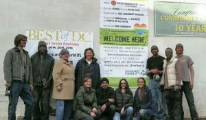 The Main Street Alliance is urging businesses nationwide to print out and display its anti-hate posters in their offices and shop-fronts. Community Forklift turned theirs into a huge banner, seen here hagning in front of their Maryland warehouse store with several employees. Photo courtesy of Community Forklift.