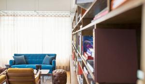 living room with messy bookshelf