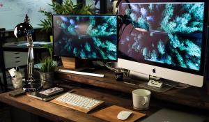 Image: two-screen computer desk set-up. Topic: Sustainable Computer Options