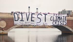 Boston-area university students gather for a joint banner drop over the Charles River to urge fossil fuel divestment.