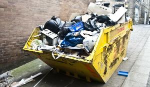 Image: full dumpster. Title: Going Zero Waste at Our Green Festivals